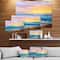Designart - Sunsets over ocean waves - Sea & Shore Painting Print on Wrapped Canvas
